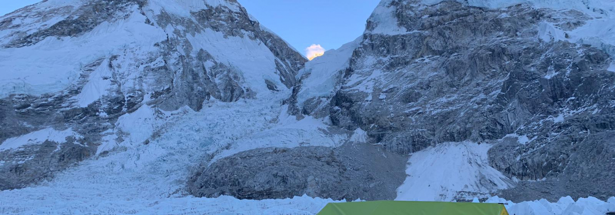 Photo of Everest Base Camp with a nearly full Moon above the Western Cwm