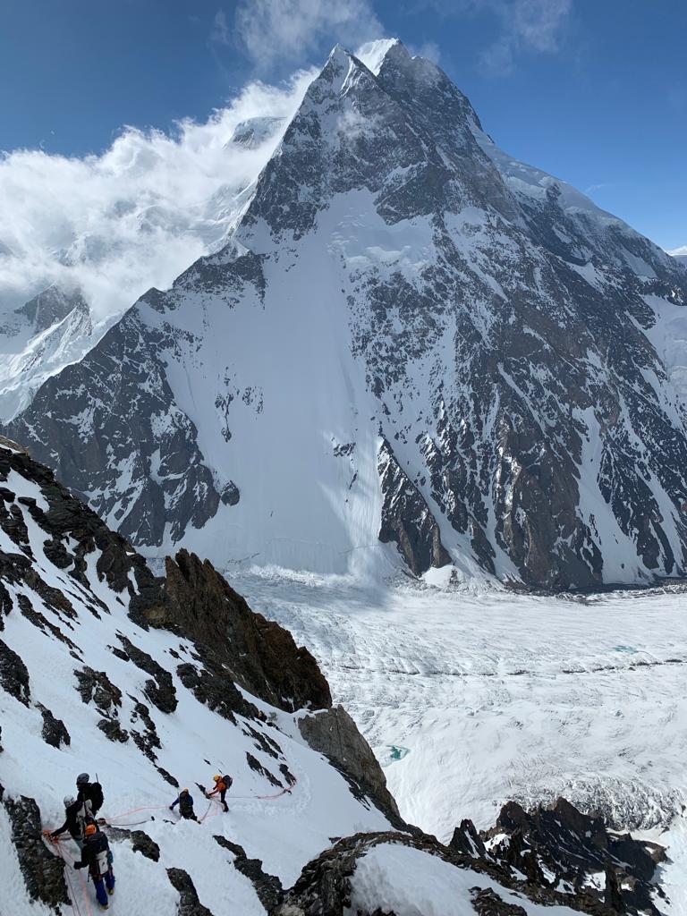 Climbers on the Cesen route with Broad Peak behind