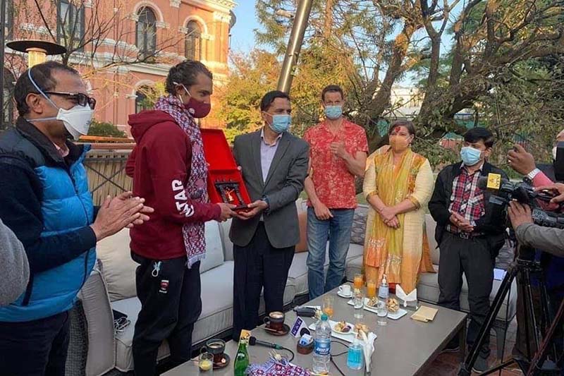 Minister for Culture, Tourism and Civil Aviation Yogesh Bhattarai felicitates team leader Garrett Madison and Prince of Qatar Sheikh Mohammed Bin Abdulla Al Thani for a successful expedition to Mt Ama Dablam at Hotel Yak and Yeti in Kathmandu, on Saturday, November 14, 2020. Photo: THT