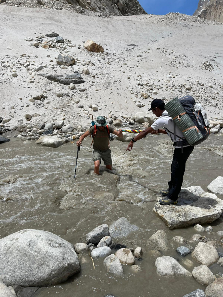 Crossing a stream while trekking from Paiju to Urdukas