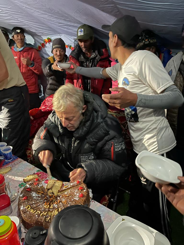 Guide Rob Smith cuts the K2 Summit Celebration cake!
