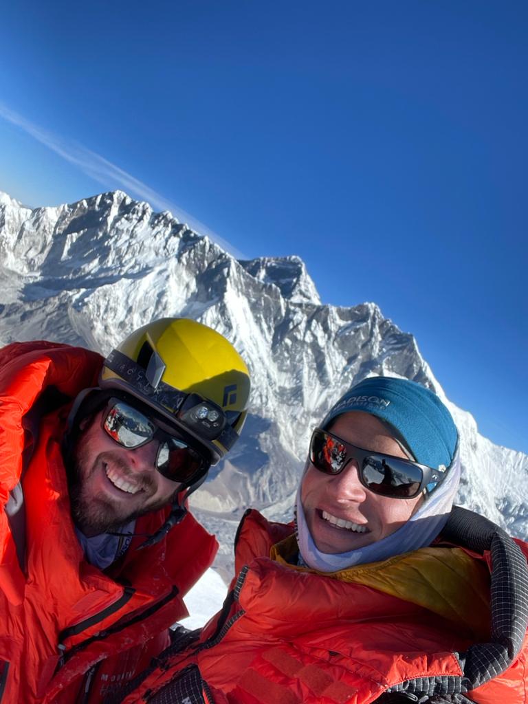 Climber Jon E. with Garrett and Mount Everest in the background from the Ama Dablam summit