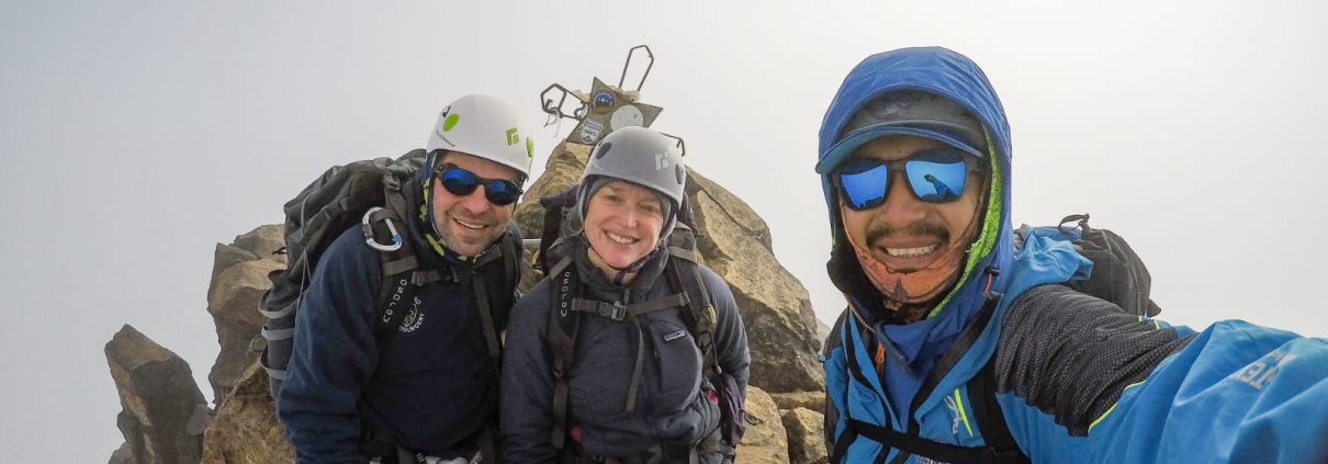 Guide Estalin Suárez and climbers Carter B. and Saskia J. on the summit of Illiniza Norte