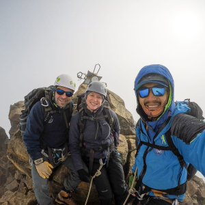 Guide Estalin Suárez and climbers Carter B. and Saskia J. on the summit of Illiniza Norte