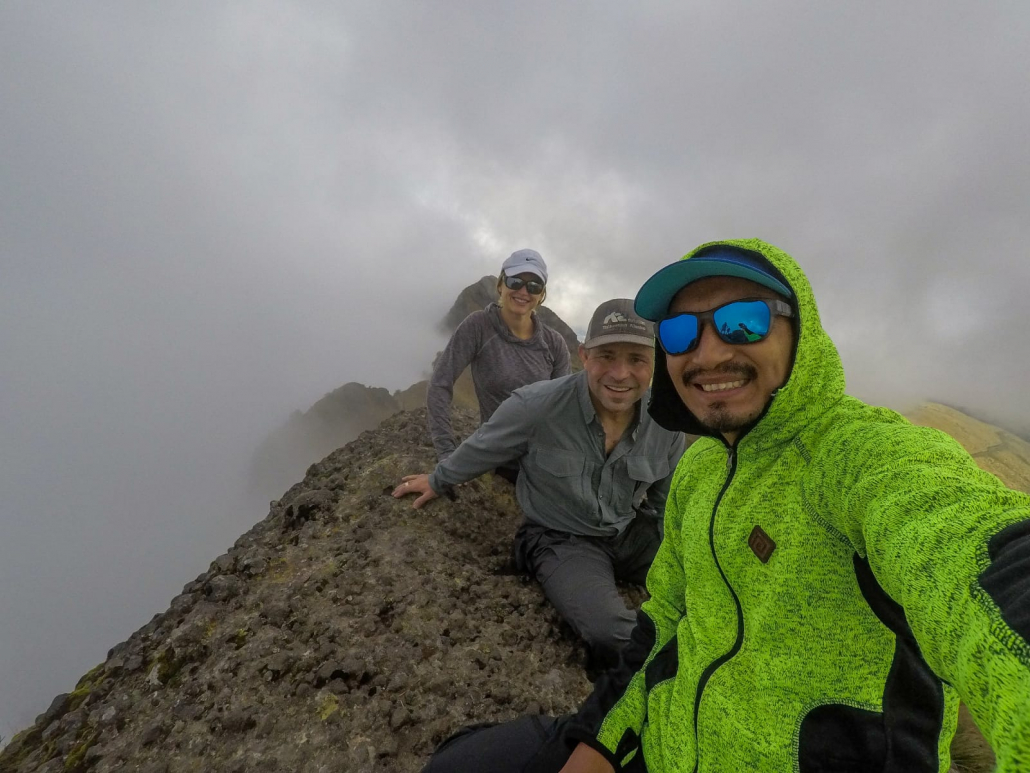 Guide Estalin Suárez and climbers Carter B. and Saskia J. on the summit of Pasochoa