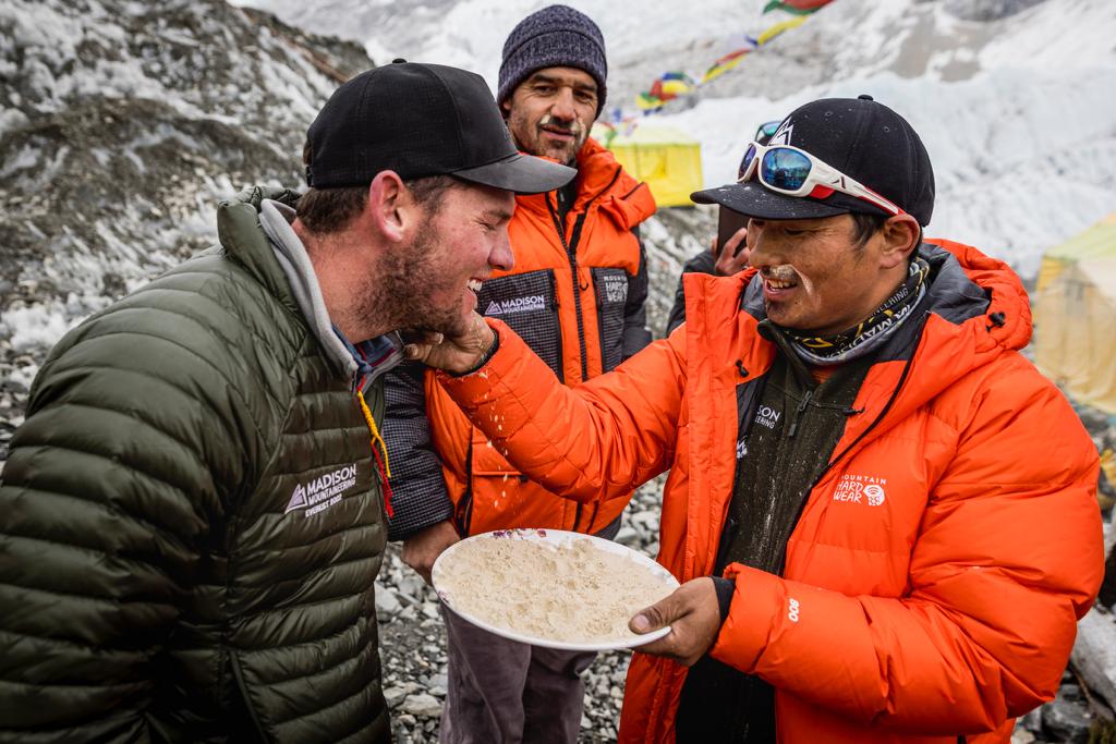 Sirdar Aang Phurba putting barley flour on climber Cameron Kenny’s face to ensure a long life