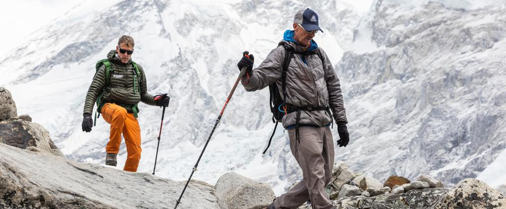 Guide Rob Smith hiking with climber Roi Negri on the flanks of Pumori above base camp