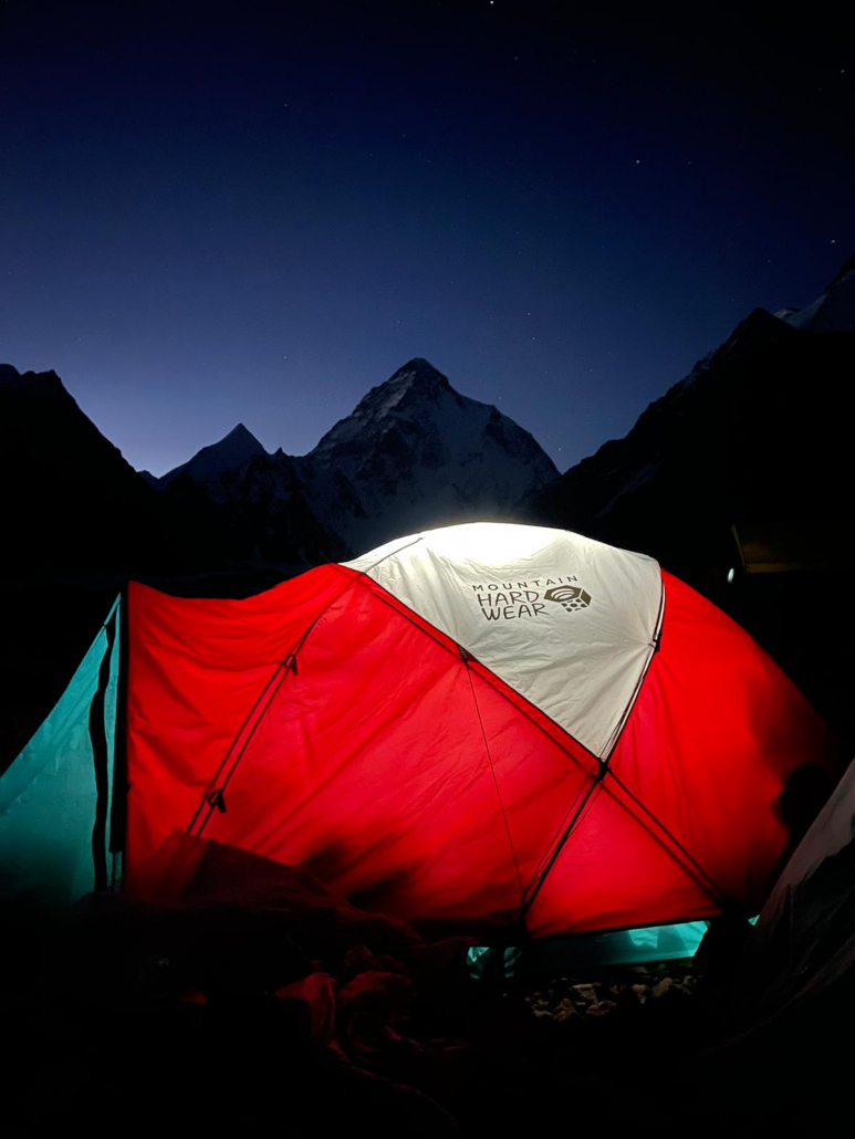 Basecamp tent illuminated at dusk