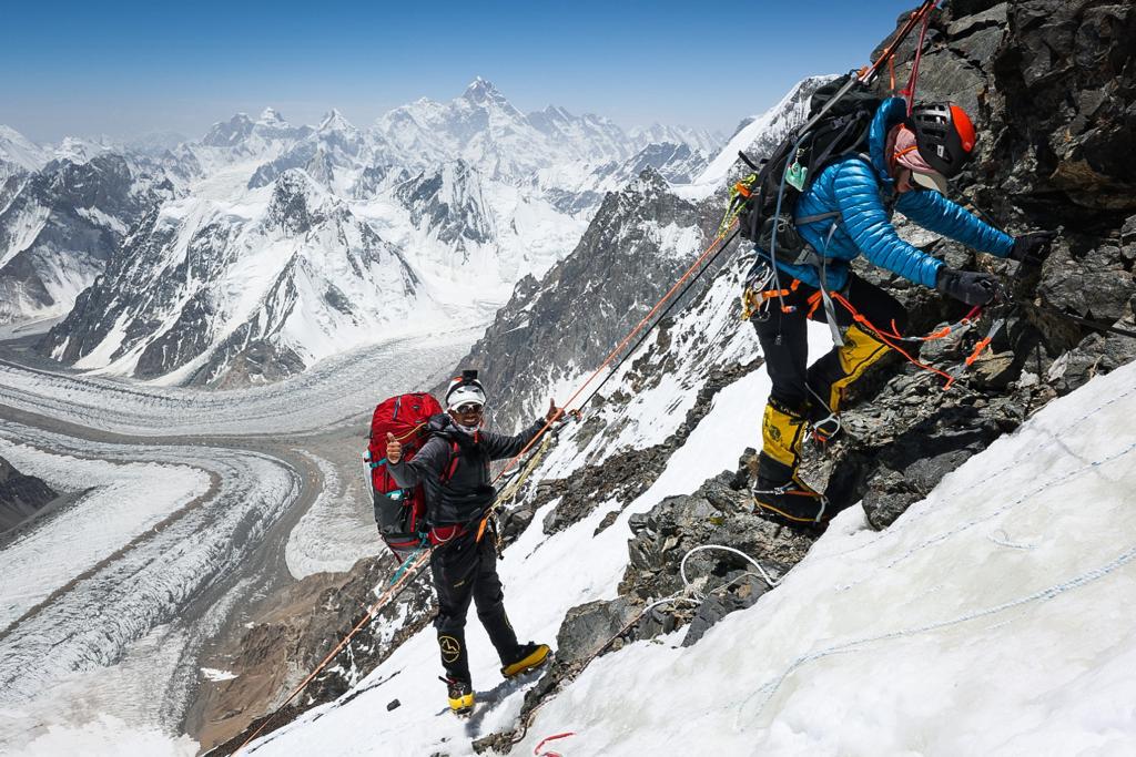 Sirdar and guide, Aang Phurba Sherpa approaching Camp 2 with climber Nelly Attar.