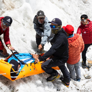 Members of our sherpa team practicing moving a victim in a rescue litter near base camp today (📸: @terray_s)