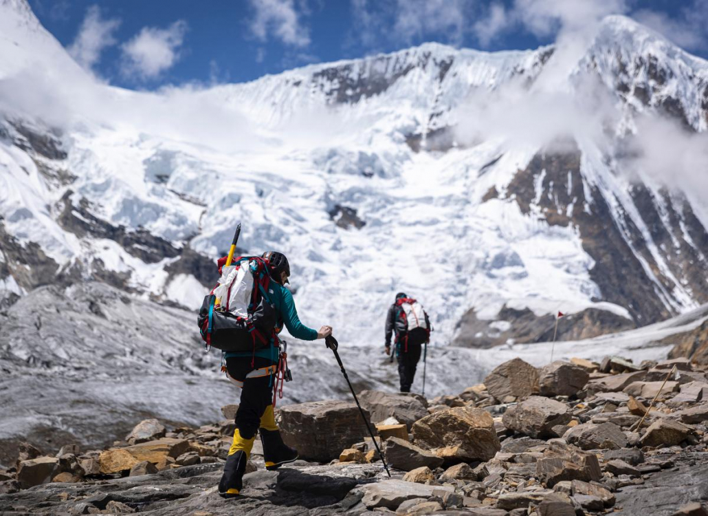Our climber, Nancy, hiking below Camp 1 with sirdar and guide Aang Phurba Sherpa. Photo: Terray Sylvester