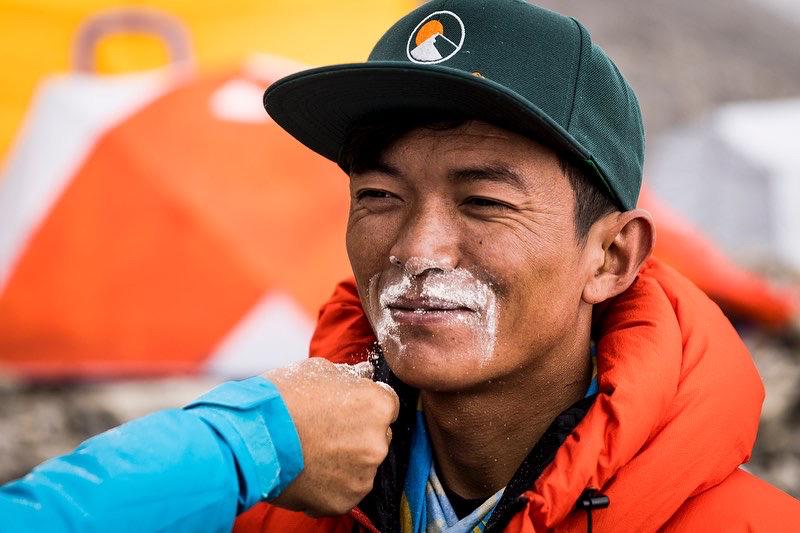 Lakpa Sherpa receiving a tsampa mustache, a blessing for a long and healthy life. Photo: Terray Sylvester