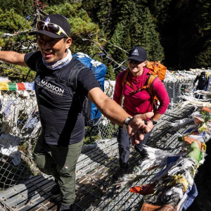 Sirdar and Guide, Aang Phurba Sherpa crossing the famous suspension bridge below Namche with Guide, Hannah Smith. Photo: Terray Sylvester