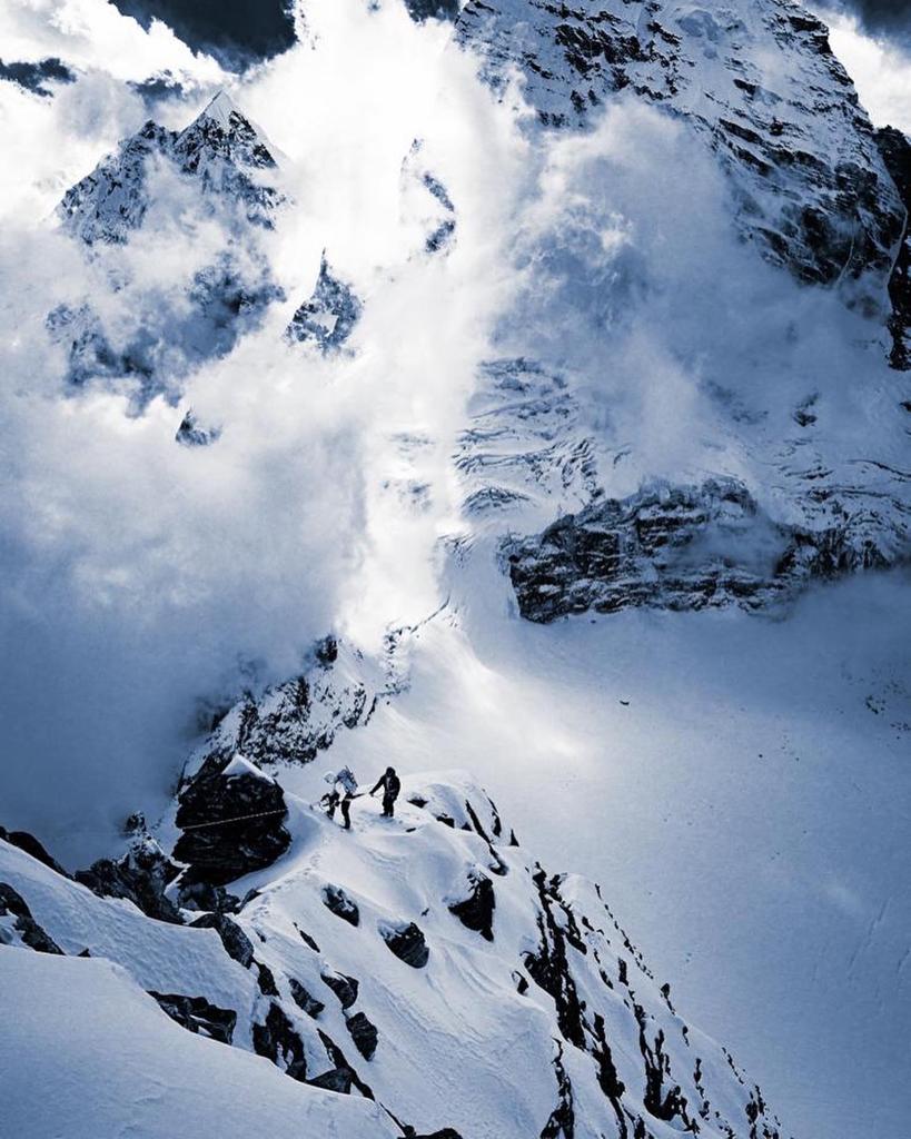 Climbers high in the alpine on the unclimbed peak. Photo: Ted Hesser