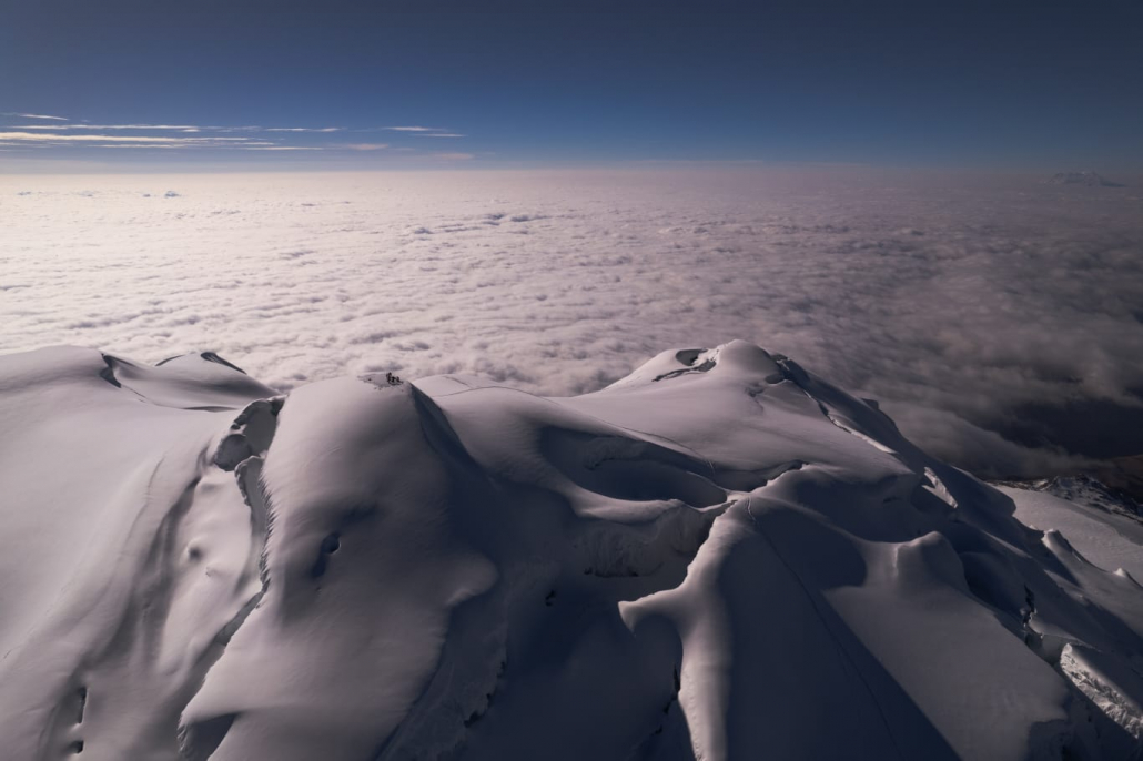 Aerial photo of the summit of Cayambe, sitting above the clouds.