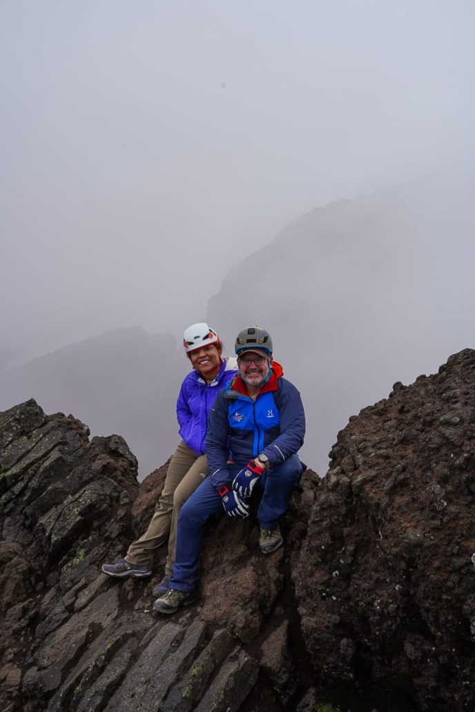 Climbers, Drew and Madison, taking a break on the summit ridge amongst the clouds!
