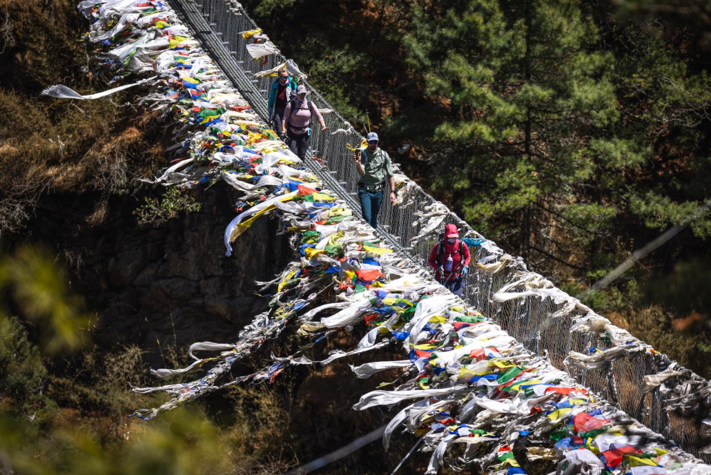 Climbers crossing the famous suspension bridge before climbing Namche Hill. (Photo: Terray Sylvester)