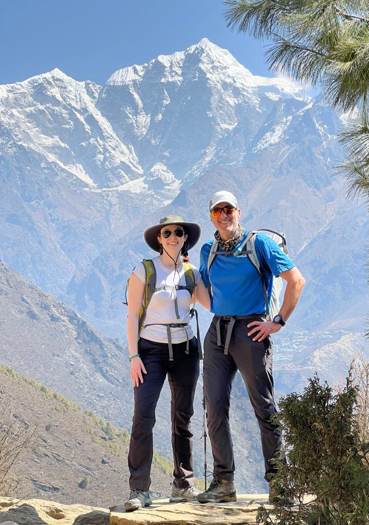Climbing and trekking duo, Rich and Sarah Draves, smiling for a photo on the trek towards EBC! 
