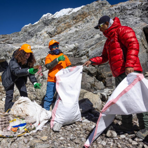 Nelly Attar (left) and Aang Phurba Sherpa cleaning up trash above Lobuche East High Camp (Photo by Terray Sylvester)