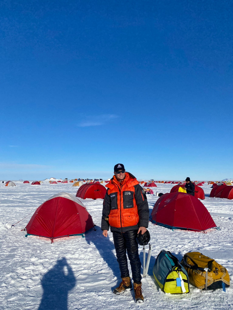 Expedition leader, Garrett Madison in Union Glacier Camp under clear blue skies!