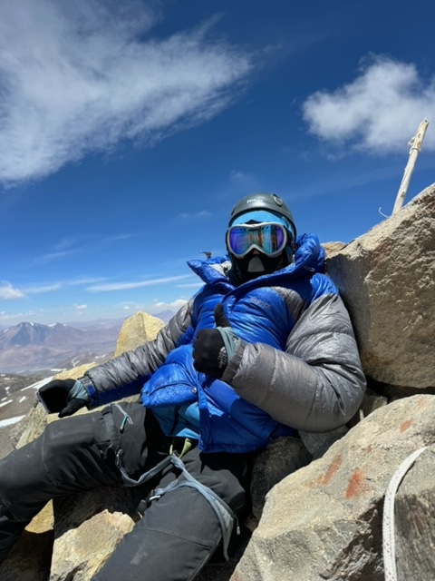 Relaxing on the summit of Ojos del Salado under blue skies!
