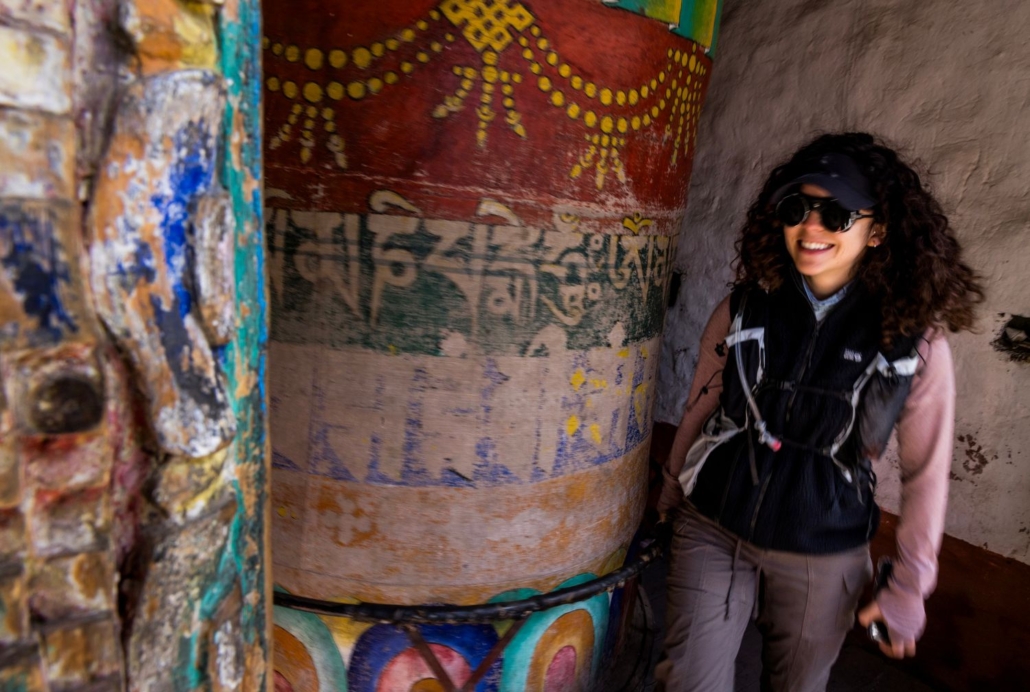 Climber, Nelly Attar spinning a prayer wheel in the famous Muktinath shrine. (Photo by Terray Sylvester)