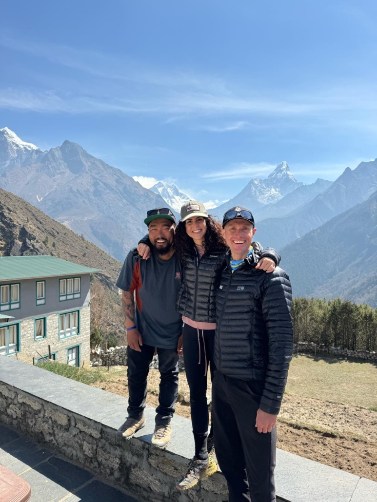 The team taking a break at Kyangjuma with great views of the Everest Massif and Ama Dablam.