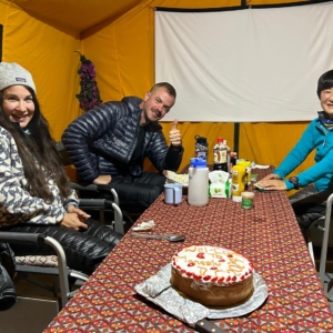 The team celebrating with a welcome cake after arriving in base camp!