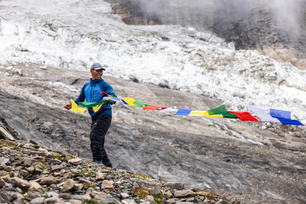 Temba stringing prayer flags over our base camp. (Photo by Terray Sylvester)