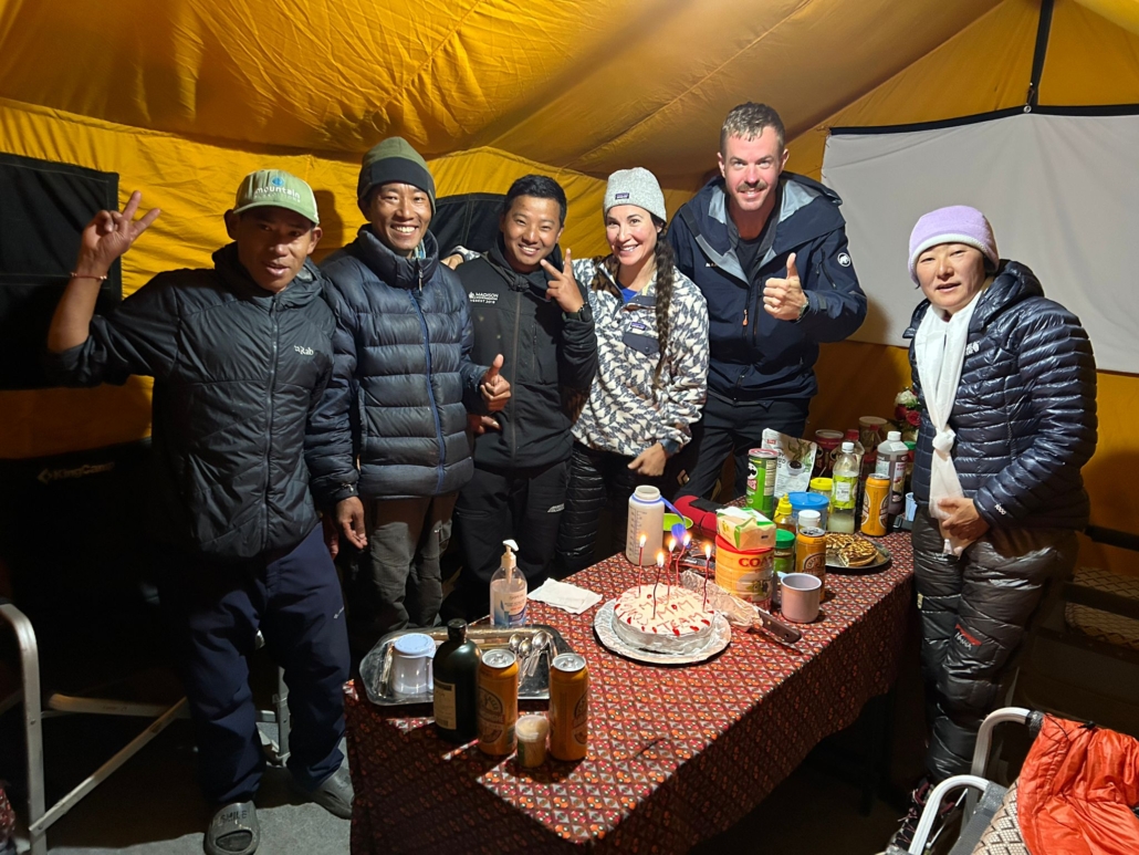 Our guests celebrating with a “summit cake” and our excellent base camp staff. From left: Khumba, Ram Kumar, and Dipesh.