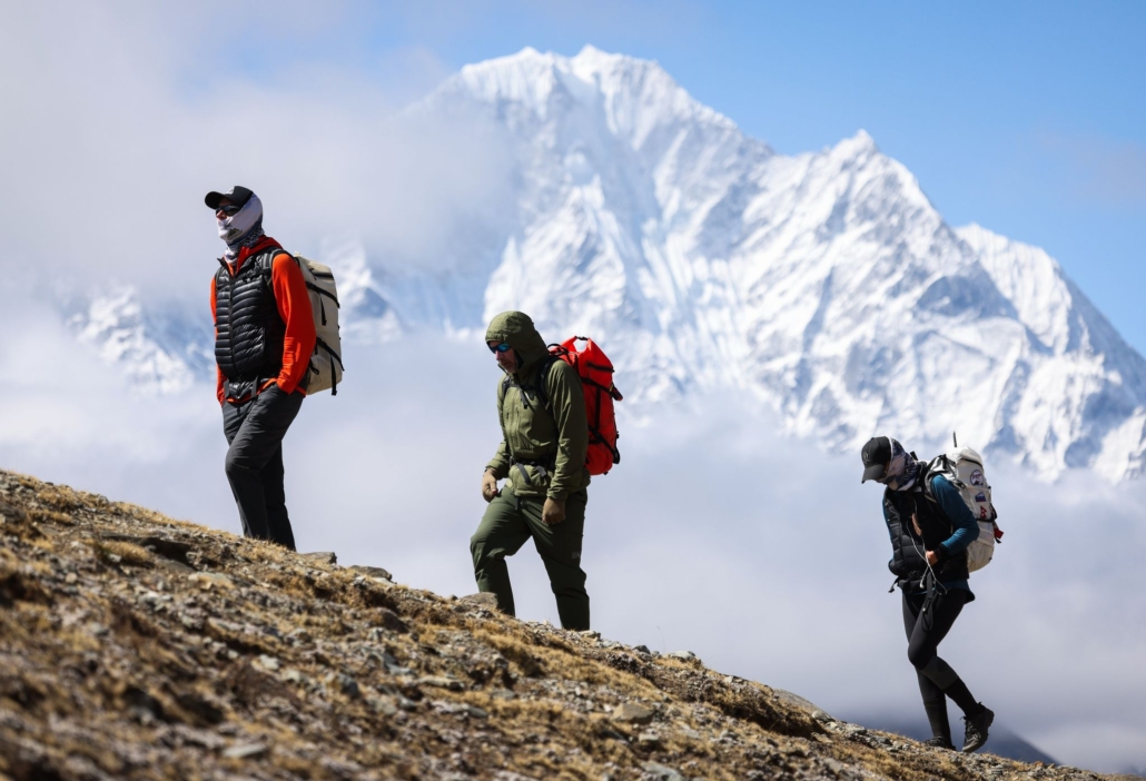 Garrett Madison with climbers Mike and Caroline in front of Thamserku peak (photo by Terray Sylvester)