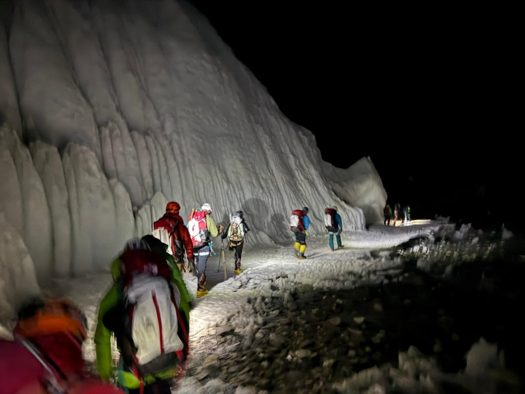 Headlamps piercing the darkness and illuminating the route ahead.