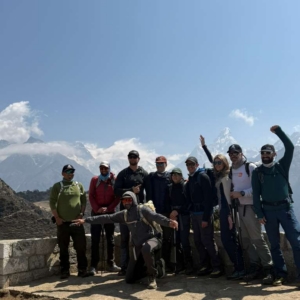 The team at the Everest View Hotel with Ama Dablam and Everest peaking out from the clouds behind.