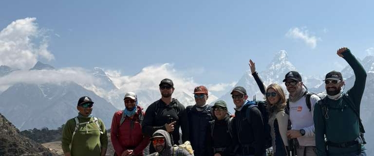 The team at the Everest View Hotel with Ama Dablam and Everest peaking out from the clouds behind.