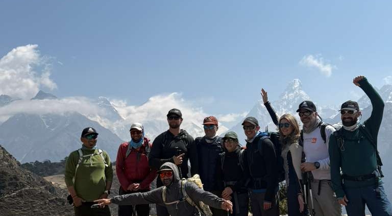 The team at the Everest View Hotel with Ama Dablam and Everest peaking out from the clouds behind.