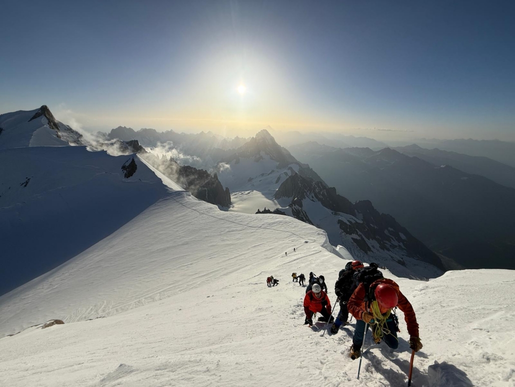 Climbing towards the summit under sunny morning skies.
