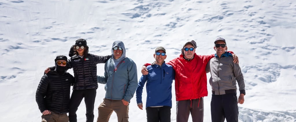 The team on top of Domashniy (Home) Peak with Peak Lenin in the background (photo by Terray Sylvester)