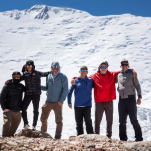 The team on top of Domashniy (Home) Peak with Peak Lenin in the background (photo by Terray Sylvester)