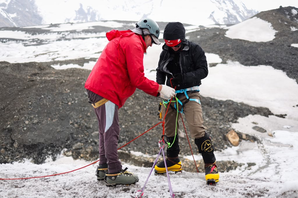 Guide Andrei Kuznetsov working with Chris, one of our Lenin Peak climbers. (Photo by Terray Sylvester)