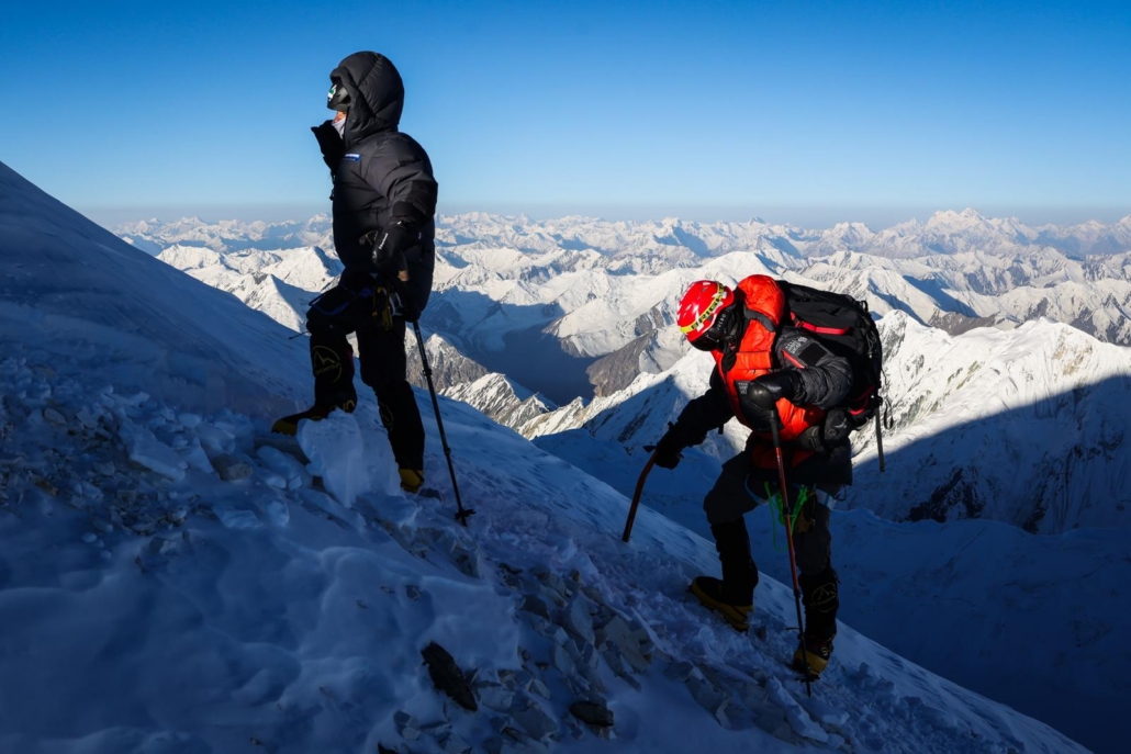 Our climbers Fatima and Chris approaching 7,000 meters with the peaks of Tajikistan in the distance (photo by Terray Sylvester)