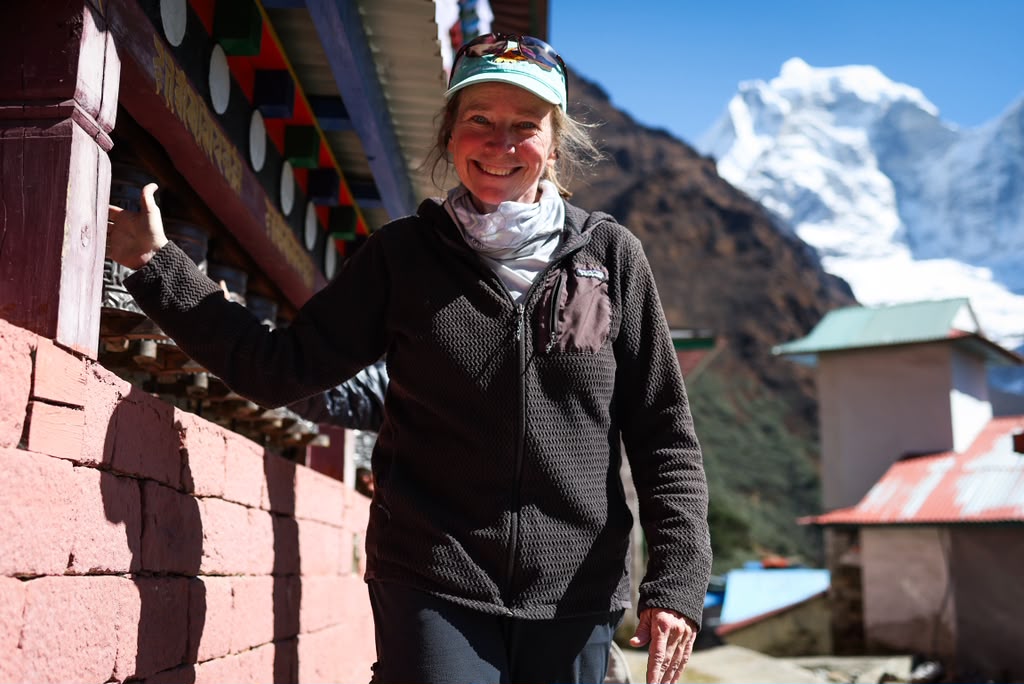 Our climber, Rhonda, spinning prayer wheels at Tengboche Monastery (photo by Terray Sylvester)